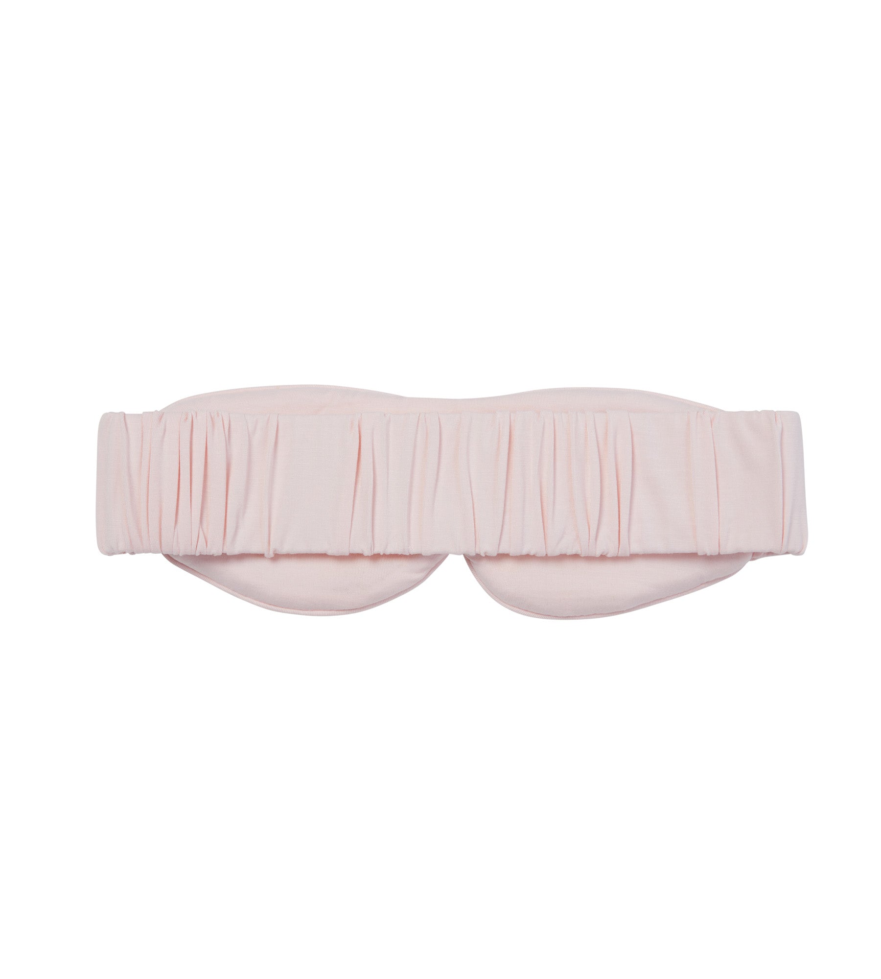 A light pink sleep mask with a gathered, pleated design across the top and a wide elastic strap, shown against a plain white background.
