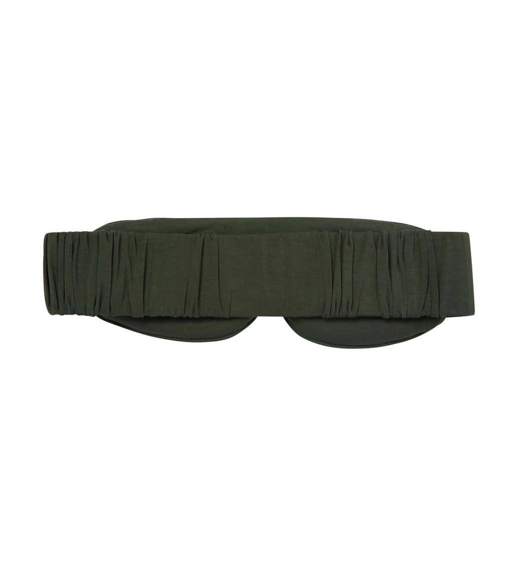 The back of an olive green eye mask with a gathered elastic strap, shown flat against a solid white background.