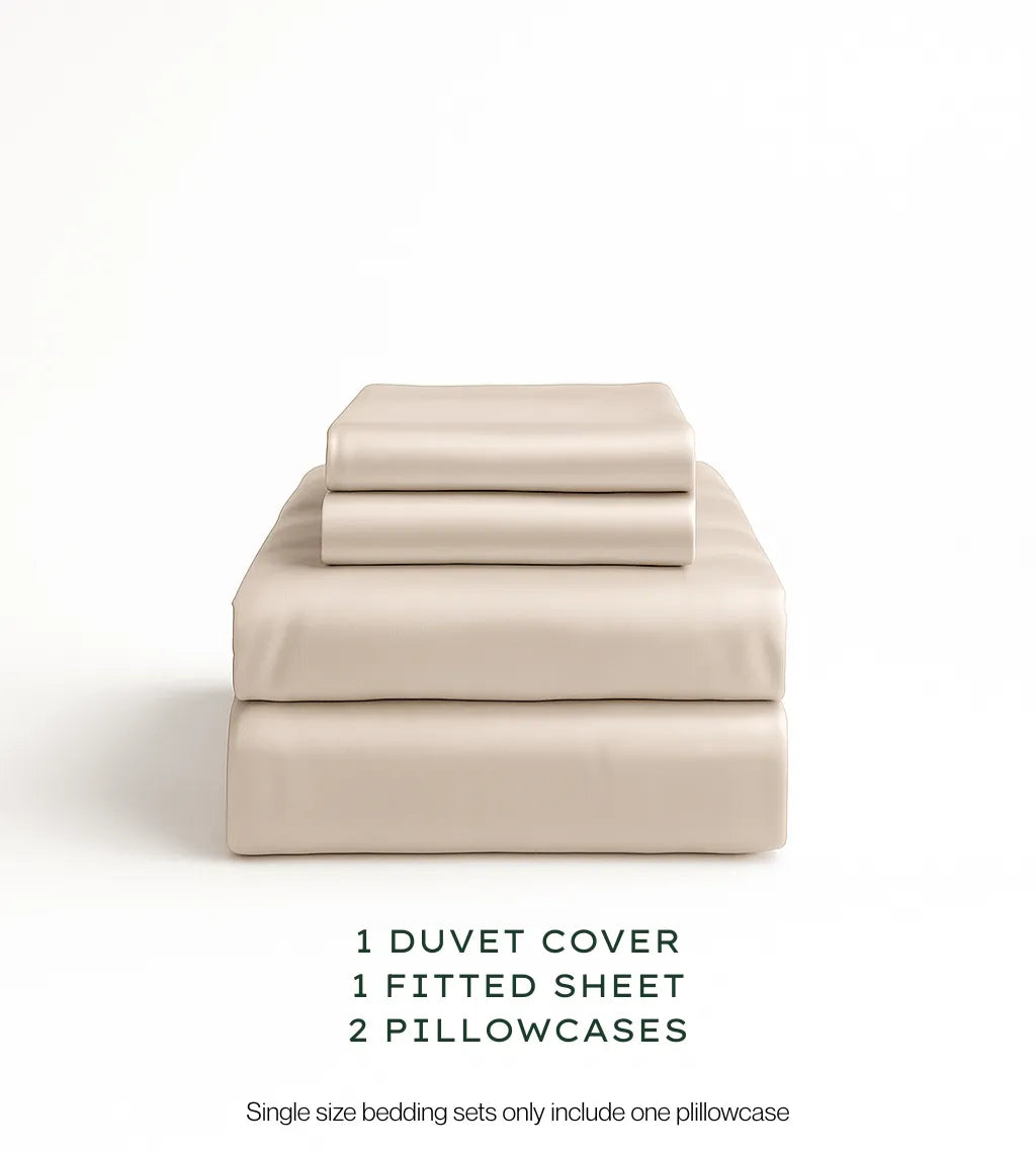 Oatmeal bedding set with duvet cover, fitted sheet, and pillowcases on a white background.