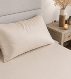 Oatmeal fitted sheet on bed