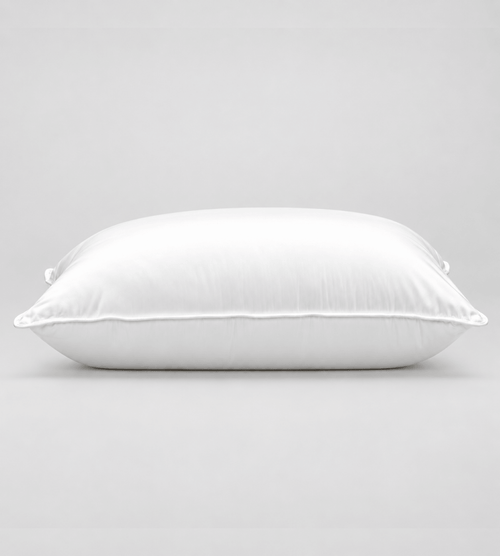 A white rectangular pillow with a smooth satin-like finish, photographed against a neutral light grey background.