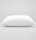 A white rectangular pillow with a smooth satin-like finish, photographed against a neutral light grey background.