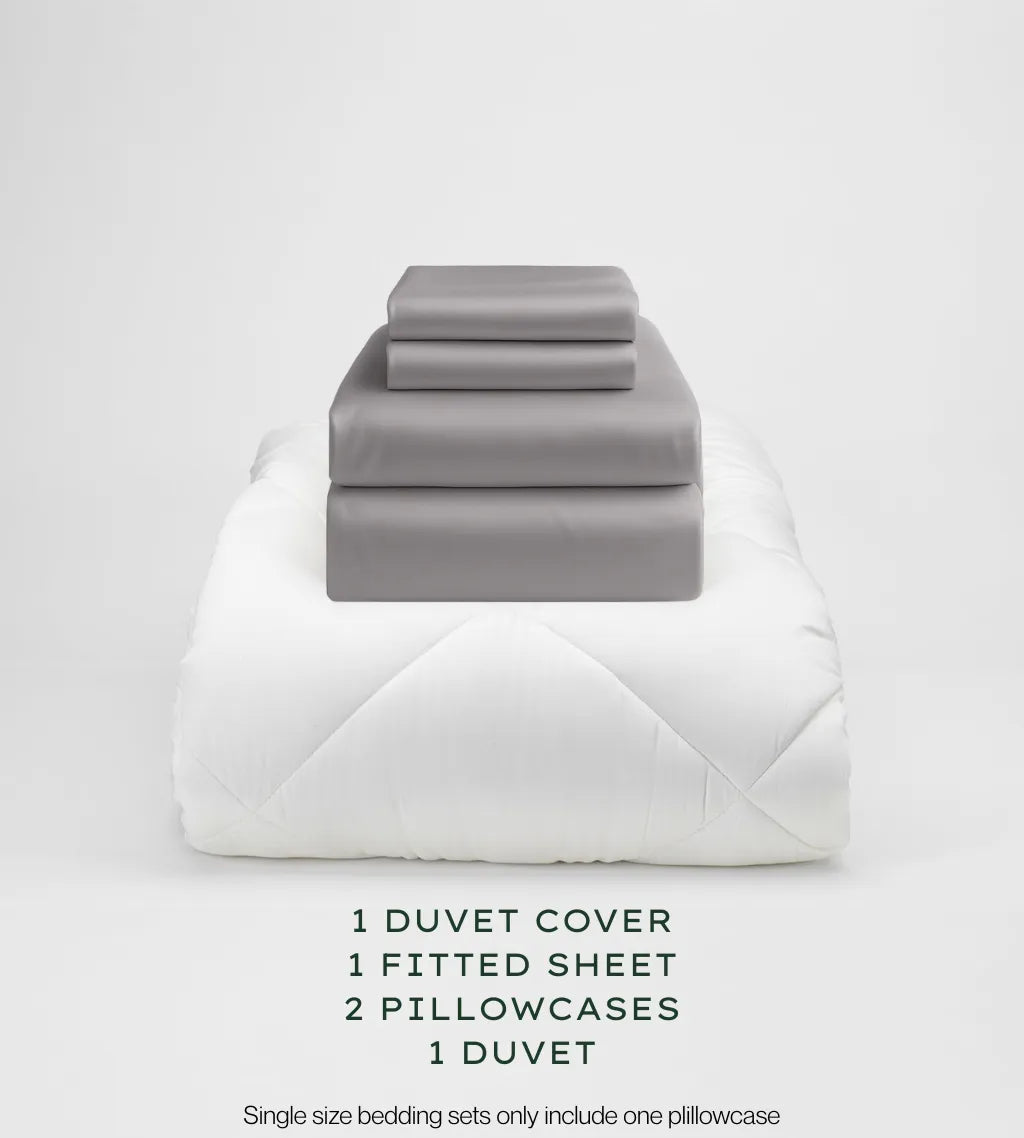 Warm Grey bedding set with duvet, duvet cover, fitted sheet, and pillowcases on a light gray background.