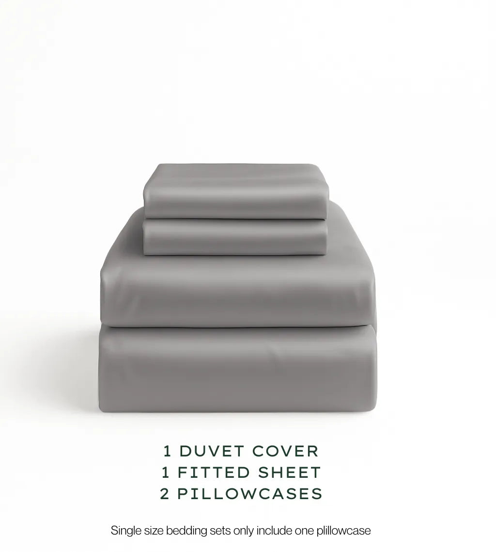 Warm Grey bedding set with duvet cover, fitted sheet, and pillowcases on a white background.