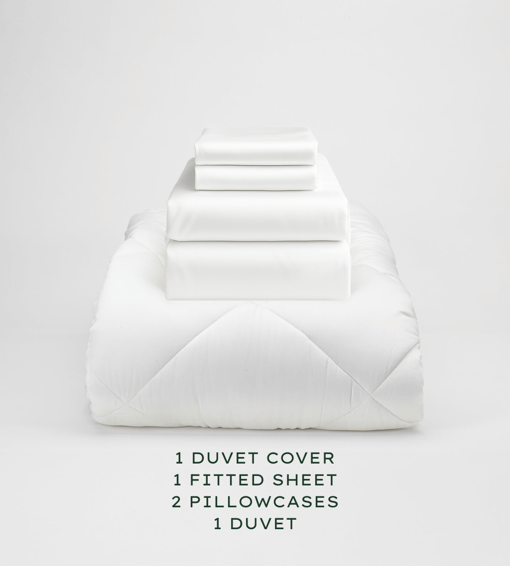 Set of white bedding including a duvet cover, fitted sheet, and pillowcases on a light gray background.