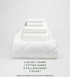 White bedding set with duvet, duvet cover, fitted sheet, and pillowcases on a light gray background.