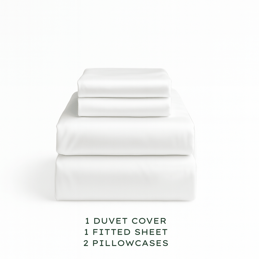White bedding set with duvet cover, fitted sheet, and pillowcases on a white background